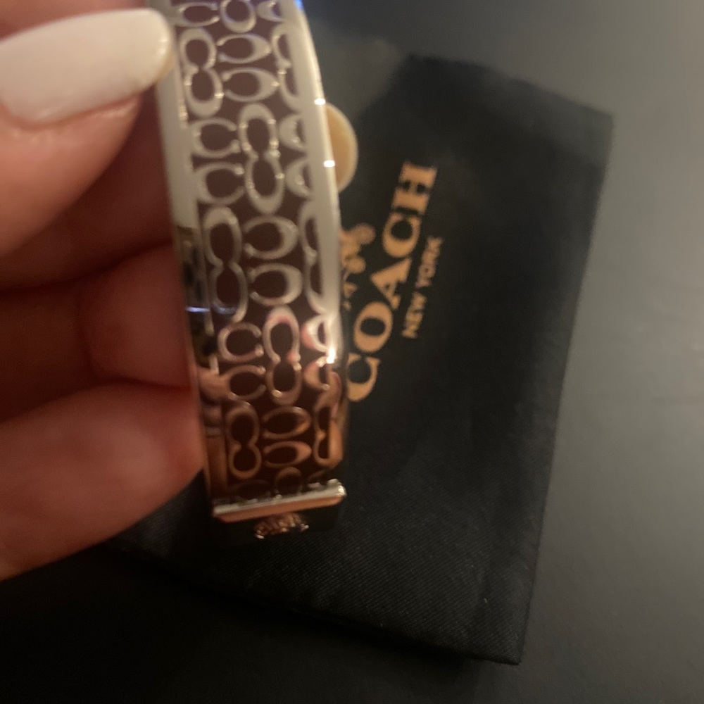 Coach bracelet with wine color and silver logo